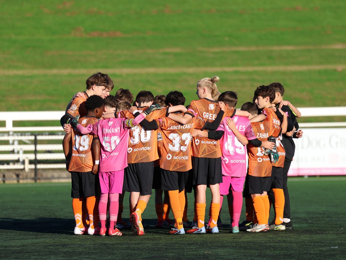 Blacktown Spartans Boys' Youth League players in a team huddle